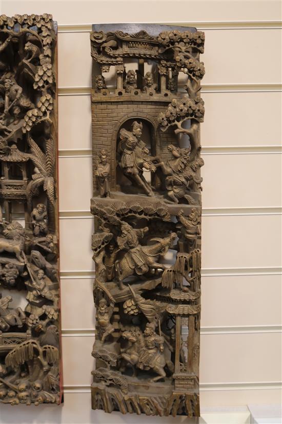 Four Chinese carved giltwood panels of battle scenes